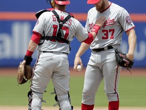Washington Nationals catcher Yan Gomes (10) talks to starting pitcher Stephen Strasburg (37) during the fourth inning of a baseball game against the New York Mets, Thursday, May 23, 2019, in New York.