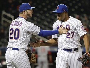 New York Mets' Pete Alonso (20) encourages relief pitcher Jeurys Familia (27) during the eighth inning of a baseball game against the Cincinnati Reds Monday, April 29, 2019, in New York. The Reds won 5-4.