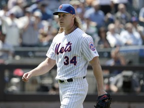 New York Mets starting pitcher Noah Syndergaard walks off the field after pitching to the Cincinnati Reds during the eight inning of a baseball game, Thursday, May 2, 2019, in New York. The Mets won 1-0.