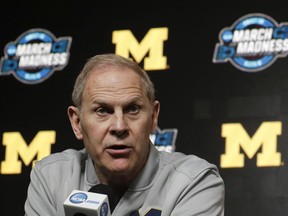FILE - In this March 27, 2019 file photo Michigan head coach John Beilein speaks during a news conference at the NCAA college basketball tournament in Anaheim, Calif. Two people familiar with the decision say Beilein has agreed to become head coach of the Cleveland Cavaliers. The people spoke to The Associated Press on Monday, May 13, 2019 on condition of anonymity because the team had not announced the hire. ESPN, citing unidentified sources, said Beilein agreed to a five-year deal with the Cavaliers.