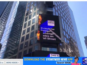 In this image from video provided by WABC TV, flames shoot from the digital billboard at 3 Times Square in New York City, Saturday, May 18, 2019. The Fire Department says no injuries have been reported and there was no damage to the building the sign is attached to. (WABC TV via AP)