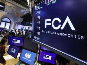 The Fiat Chrysler Automobiles logo appears above a post on the floor of the New York Stock Exchange, Tuesday, May 28, 2019. Fiat Chrysler is proposing a merger with French carmaker Renault aimed at saving billions of dollars for both companies.