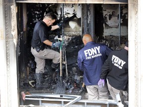 Fire marshals sift through a burned out apartment in New York's Harlem neighborhood, Wednesday, May 8, 2019. Six people, including four children, were killed Wednesday when an overnight fire ravaged an apartment in a city-owned Harlem building.