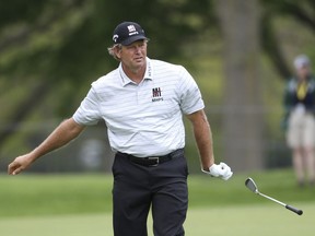 Retief Goosen flips his club after coming up short trying to hit onto the 18th green during the first round of the Senior PGA Championship golf tournament Thursday, May 23, 2019, at Oak Hill in Rochester, N.Y.