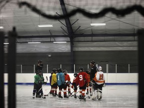 FILE - In this Feb. 21, 2019, file photo, Malakye Johnson (1) gathers with his teammates during a Snider Hockey practice at the Scanlon Ice Rink in Philadelphia. The Philadelphia-based Snider Hockey organization named after the late Flyers owner now has over 3,000 kids in its program and almost a third are girls. Snider Hockey officials want to get to a point that boys and girls are split 50-50, and a new endeavor with the Howe Foundation is another step toward that goal.