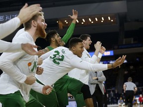 FILE - In this Saturday, March 10, 2018, file photo, then-Marshall guard Phil Bledsoe (32) and the Marshall bench react to a 3-point shot against Western Kentucky during the second half of the NCAA Conference USA basketball championship game in Frisco, Texas. Confusion over the new rule allowing college basketball players to sign with agents has led to uncertainty for Bledsoe, now at Division II Glenville State in West Virginia.