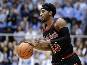 FILE - In this Monday, Nov. 19, 2018, file photo, St. Francis guard Keith Braxton (13) dribbles the ball during the second half of an NCAA college basketball game against North Carolina in Chapel Hill, N.C. The rule adopted by the NCAA amid the college basketball scandal and that is designed to help players explore their pro potential and still return to school surprisingly applies only to Division I players. Braxton, a 6-5 guard, signed with an agent but hopes he has generated NBA interest as he returns for his senior season after withdrawing from the draft.