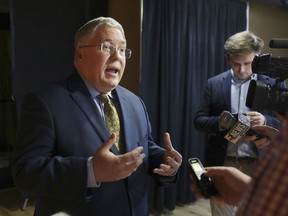 FILE - In this Nov. 1, 2018, file photo, Patrick Morrisey speaks to reporters after a debate in Morgantown, W.Va. West Virginia's Roman Catholic diocese has released the names of nine more priests who it said have been credibly accused of child sexual abuse. West Virginia Attorney General Patrick Morrisey in March 2019 filed a lawsuit accusing the diocese and former Bishop Michael Bransfield of knowingly employing pedophiles and failing to conduct adequate background checks on camp and school workers.