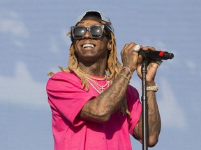 FILE - In a June 16, 2018 file photo, Lil Wayne performs on Day 3 of the 2018 Firefly Music Festival at The Woodlands, in Dover, Del. Rap star Lil Wayne says he did not perform as scheduled Saturday, May 11, 2019 at the Rolling Loud festival at Hard Rock Stadium in Miami Gardens because he was searched by law enforcement officers. The rapper said on social media Saturday that he would not perform at the Rolling Loud festival at Hard Rock Stadium in Miami Gardens because police "made it mandatory" that he was searched before the show. Rapper Kodak Black was arrested on weapons charges before the show.