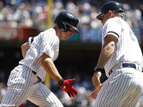 New York Yankees' Brett Gardner celebrates with third base coach Phil Nevin after hitting a two-run home run against the San Diego Padres during the second inning of a baseball game, Monday, May 27, 2019, in New York. Yankees' Gio Urshela also scored.