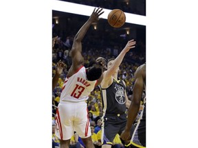 Houston Rockets' James Harden (13) drives to the basket as Golden State Warriors' Jonas Jerebko (21) defends during the first half of Game 2 of a second-round NBA basketball playoff series in Oakland, Calif., Tuesday, April 30, 2019.