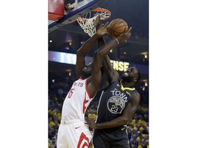 Houston Rockets' Clint Capela, left, is defended by Golden State Warriors' Draymond Green during the first half of Game 2 of a second-round NBA basketball playoff series in Oakland, Calif., Tuesday, April 30, 2019.