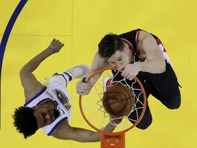 Portland Trail Blazers forward Zach Collins, right, dunks against Golden State Warriors guard Quinn Cook during the second half of Game 1 of the NBA basketball playoffs Western Conference finals in Oakland, Calif., Tuesday, May 14, 2019.