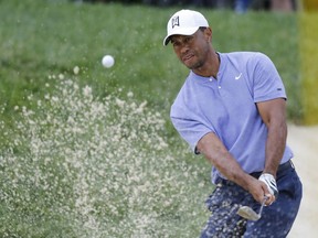Tiger Woods hits from the sand on the 13th hole during the first round of the Memorial golf tournament Thursday, May 30, 2019, in Dublin, Ohio.
