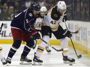 Columbus Blue Jackets forward Artemi Panarin, left, of Russia, works against Boston Bruins forward David Backes during the first period of Game 4 of an NHL hockey second-round playoff series in Columbus, Ohio, Thursday, May 2, 2019.