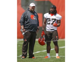 Cleveland Browns' Kareem Hunt (27) talks with head coach Freddie Kitchens during an NFL football organized team activity session at the team's training facility Wednesday, May 15, 2019, in Berea, Ohio.