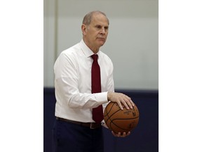 Cleveland Cavaliers head coach John Beilein talks with players before a news conference, Tuesday, May 21, 2019, in Independence, Ohio. Beilein left Michigan after a successful 12-year run for what will likely be his last coaching stop, the Cleveland Cavaliers, who believe the 66-year-old can accelerate their rebuild.