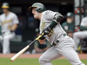 Oakland Athletics' Mark Canha watches his ball after hitting against Cleveland Indians starting pitcher Jefry Rodriguez in the first inning of a baseball game, Wednesday, May 22, 2019, in Cleveland. Canha grounded into a fielders choice. Marcus Semien scored on the play.