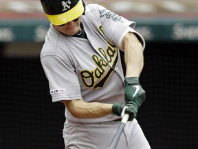 Oakland Athletics' Nick Hundley hits an one-run double off Cleveland Indians relief pitcher Tyler Clippard in the seventh inning of a baseball game, Wednesday, May 22, 2019, in Cleveland. Ramon Laureano scored on the play.