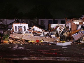 Police stand at the ruins of a hotel in El Reno, Okla., Sunday, May 26, 2019, following a likely tornado touchdown late Saturday night.