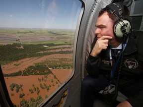 Oklahoma Gov. Kevin Stitt surveys flooding damage near Minco, Okla., from the air Tuesday, May 21, 2019, following heavy rains across the state.