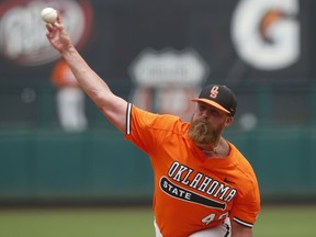 Oklahoma State starting pitcher Brett Standlee throws in the second inning of the championship game of the NCAA college Big 12 baseball tournament against West Virginia, Sunday, May 26, 2019, in Oklahoma City.