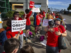 Teachers and supporters gather at the intersection of 29th Ave. and Willamette St. in Eugene, Ore, Wednesday, May 8, 2019, during a walkout in support of more funding for education in Oregon.