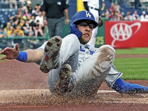 Los Angeles Dodgers' Matt Beaty scores on a double by Max Muncy off Pittsburgh Pirates starting pitcher Michael Feliz during the first inning of a baseball game in Pittsburgh, Friday, May 24, 2019.
