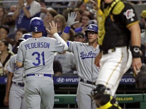 Los Angeles Dodgers' Joc Pederson (31) makes his way to the dugout after scoring on a single by Corey Seager off Pittsburgh Pirates starting pitcher Joe Musgrove during the first inning of a baseball game in Pittsburgh, Saturday, May 25, 2019.