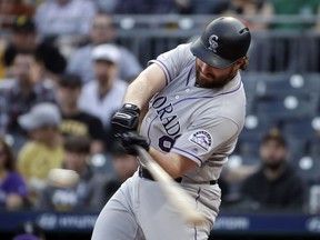Colorado Rockies' Daniel Murphy hits a three-run home run off Pittsburgh Pirates starting pitcher Montana DuRapau during the first inning of a baseball game in Pittsburgh, Wednesday, May 22, 2019.