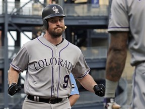 Colorado Rockies' Daniel Murphy (9) is greeted after crossing home plate on his three-run home run off Pittsburgh Pirates starting pitcher Montana DuRapau during the first inning of a baseball game in Pittsburgh, Wednesday, May 22, 2019.