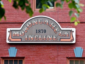 A sign marks the lower terminal of the Monongahela Incline on Friday, May 10, 2019, in Pittsburgh. The incline that transports people up and down the side of a hill in Pittsburgh reopened Friday after being closed since February.