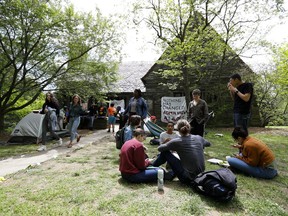 FILE - In this April 29, 2019, file photo, Swarthmore College students gather outside the Phi Psi fraternity house during a sit-in, in Swarthmore, Pa. Students at the suburban Philadelphia college have occupied the on-campus fraternity house in an effort to get it shut down after documents allegedly belonging to Phi Psi surfaced containing derogatory comments about women and the LGBTQ community and jokes about sexual assault. School President Valerie Smith announced Friday, May 10, 2019 that fraternities and sororities will no longer be allowed at Swarthmore College. (AP Photo, File)