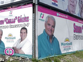 In this April 28, 2019 photo, a billboard promotes former President Ricardo Martinelli as a mayoral candidate for Panama City representing the Democratic Change party, in Panama City. Panama's electoral court ruled that the jailed ex-president may not participate in the May 5th general elections. Martinelli has been behind bars on charges of political espionage since being extradited from the U.S. last June.