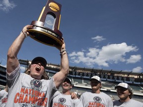 Virginia's Ryan Pride raises the trophy after defeating Yale in the NCAA college lacrosse championship in Philadelphia on Monday, May 27, 2019. Virginia beat defending champion Yale, 13-9, in the national title game Monday.