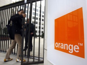 FILE - In this Oct.29, 2009 file photo, people enter the headquarters of France Telecom SA in Paris. French telecom giant Orange and seven former or current managers are going on trial Monday May 6, 2019, accused of moral harassment over a wave of employee suicides a decade ago.