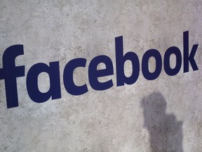 FILE - This Jan. 17, 2017, file photo shows a Facebook logo displayed in a start-up companies gathering at Paris' Station F in Paris. Facebook CEO Mark Zuckerberg will meet Friday May 10, 2019 French President Emmanuel Macron as the tech giant and France try to pioneer ways of fighting hate speech and violent extremism online.