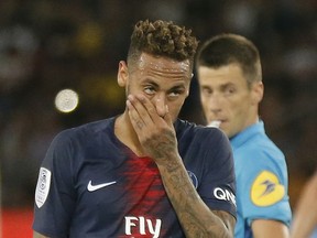 FILE - In this Aug.12 2018 file photo, PSG's Neymar reacts during a League One soccer match between Paris Saint-Germain and Caen at Parc des Princes stadium in Paris. Paris Saint-Germain striker Neymar has been given a three-game ban for lashing out at a fan following a loss in the French Cup final last month.