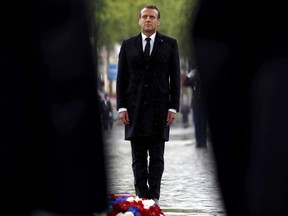 French President Emmanuel Macron attends a wreath laying ceremony to mark the 74th anniverssary of World War II victory in Europe, under the Arc de Triomphe Wednesday May 8, 2019 in Paris .