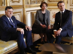 French President Emmanuel Macron, right, meets Libyan Prime Minister Fayez Sarraj Wednesday, May 8, 2019 at the Elysee Palace in Paris. Sarraj met Italian Prime Minister Giuseppe Conte Tuesday in Rome.