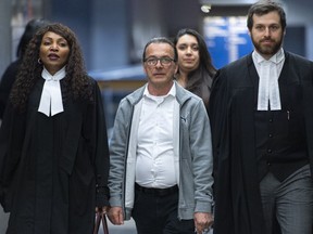 Michel Cadotte arrives at the courthouse flanked by his lawyers for his sentencing in Montreal on Tuesday, May 28, 2019.