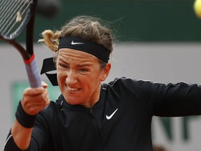 Victoria Azarenka of Belarus plays a shot against Japan's Naomi Osaka during their second round match of the French Open tennis tournament at the Roland Garros stadium in Paris, Thursday, May 30, 2019.