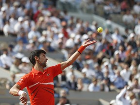 Serbia's Novak Djokovic serves against Poland's Hubert Hurkacz during their first round match of the French Open tennis tournament at the Roland Garros stadium in Paris, Monday, May 27, 2019.