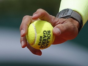 FILE - In this Monday, May 27, 2019, file photo, Spain's Rafael Nadal prepares to serve against Germany's Yannick Hanfmann during their first round match of the French Open tennis tournament at the Roland Garros stadium in Paris. English-speakers tend to go with "French Open," even though that's not used by the event itself. Most of the rest of the world says "Roland Garros," which is the facility that hosts the tournament and is named in memory of a World War I fighter pilot. But what hardly ever is uttered is the original name of the tournament "Internationaux de France", which translates to "International Championships of France."