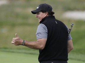 Phil Mickelson motions to fans during a practice round for the PGA Championship golf tournament, Wednesday, May 15, 2019, at Bethpage Black in Farmingdale, N.Y.
