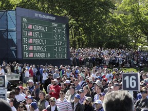 A crowd gathers at the 16th hole during the first round of the PGA Championship golf tournament, Thursday, May 16, 2019, at Bethpage Black in Farmingdale, N.Y.