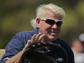 John Daly waves to golf fans as he drives down the 16th fairway during the first round of the PGA Championship golf tournament, Thursday, May 16, 2019, at Bethpage Black in Farmingdale, N.Y.