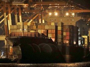 Containers are moved inside the cargo ship M/V Bavaria as it is docked at Subic port in Zambales province, northwestern Philippines on Thursday, May 30, 2019.