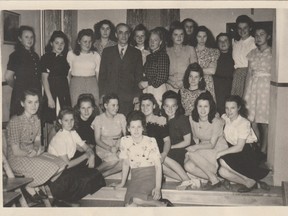 Wanda Gizmunt, seated on the second step, fourth from the right, poses with former Quebec MP Ludger Dionne, who brought displaced persons from Germany to work in his factory in what many described as forced labour conditions.