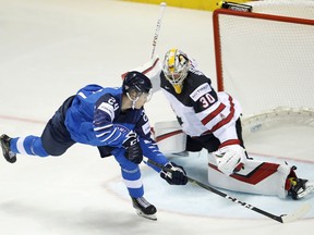 Finland's Kaapo Kakko, left, scores his sides first goal past Canada's goaltender Matt Murray, right, during the Ice Hockey World Championships group A match between Finland and Canada at the Steel Arena in Kosice, Slovakia, Friday, May 10, 2019.